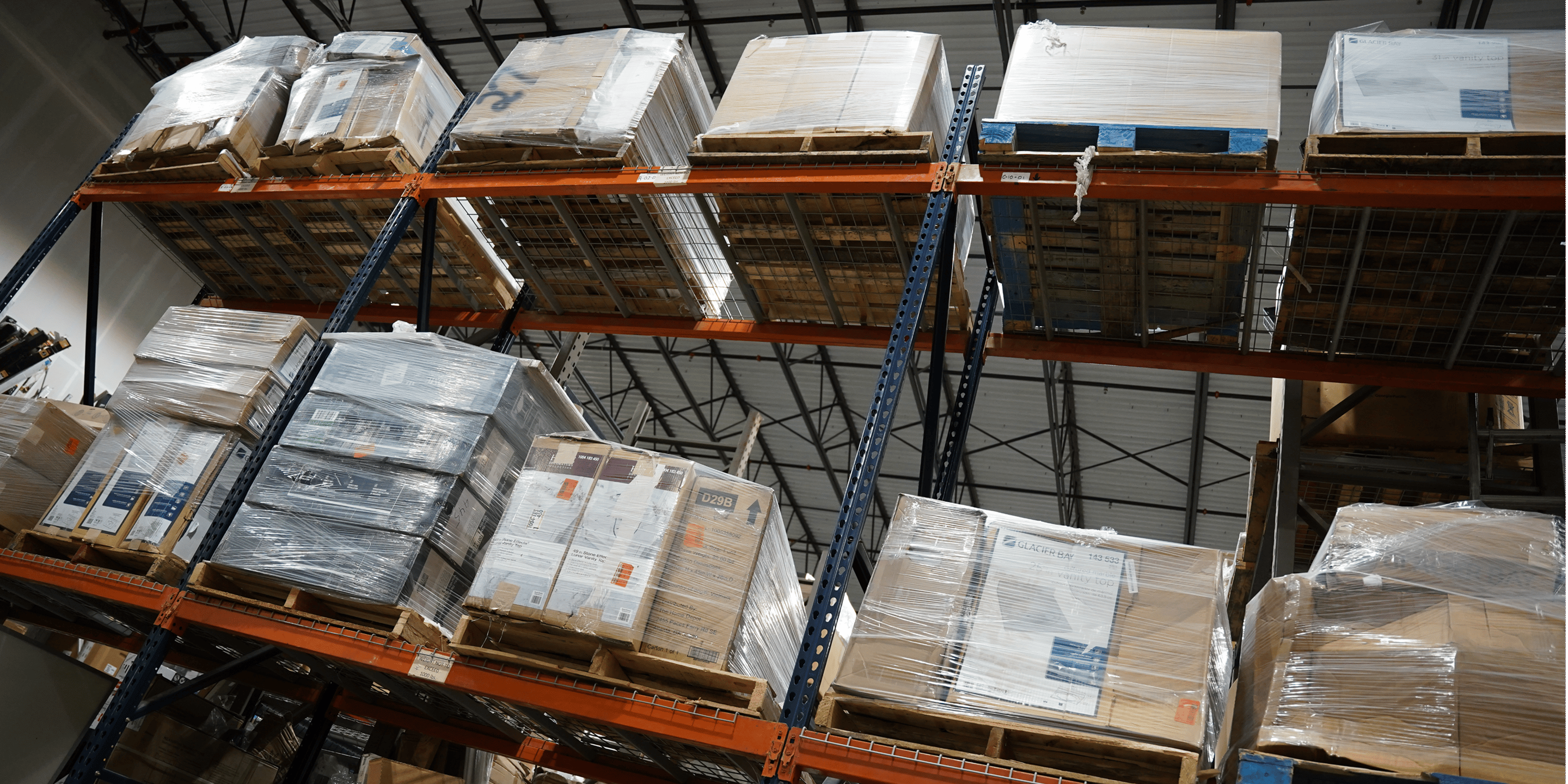 Industrial warehouse aisle stacked with returned-merchandise pallets
